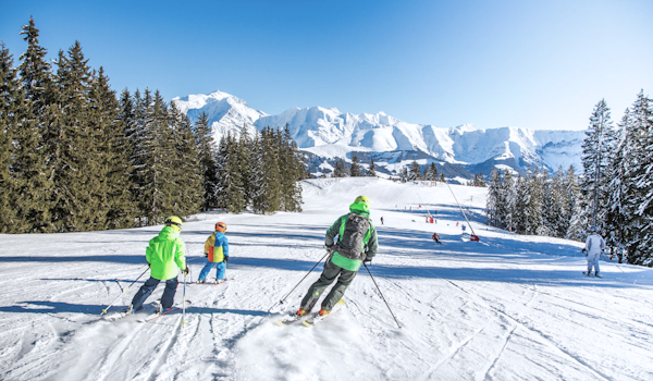 A group of people skiing down a snowy slope.