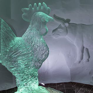 A detailed ice sculpture , displayed in a dimly lit setting.