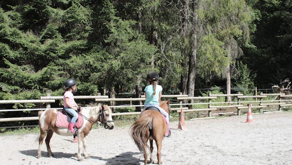 Children riding horses in a horse riding class in Les Carroz Children riding horses horse riding class Les Carroz