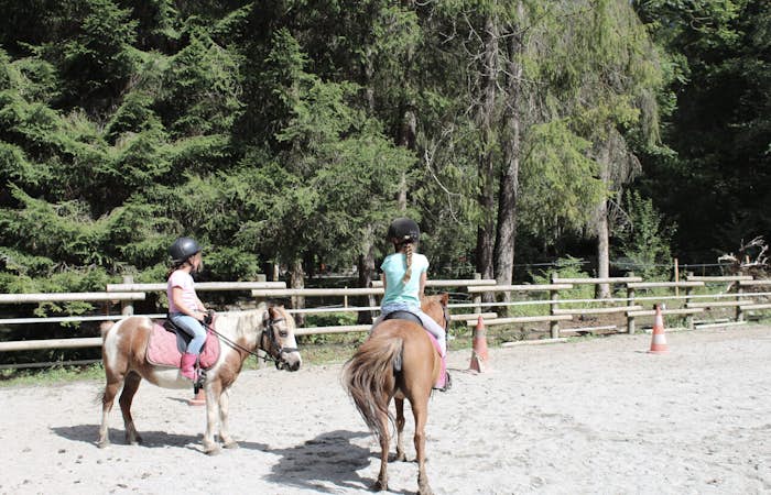 Children riding horses horse riding class Les Carroz