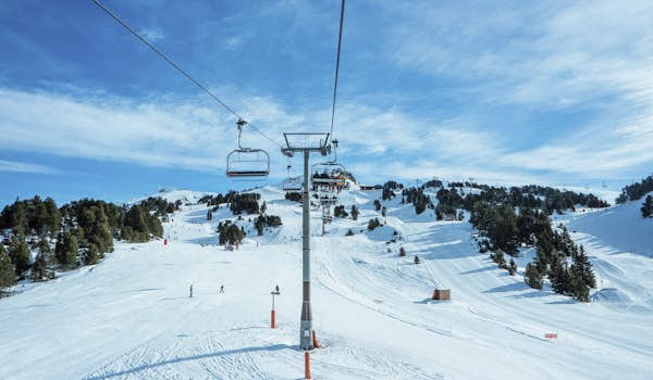 A ski lift on a snow covered slope.