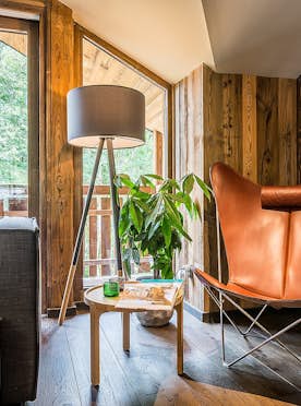 Les Gets accommodation - Chalet Moulin II - Brown leather armchair wooden side table alps chalet Moulin 2 Les Gets