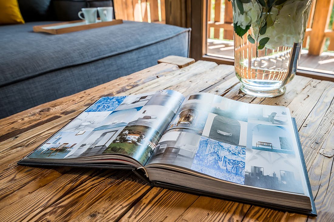 Les Gets accommodation - Chalet Moulin I - Open photography book on a wooden table in luxury chalet Moulin 1 Les Gets