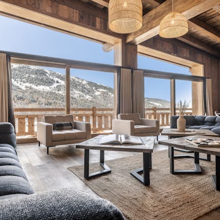 A living room with a fireplace and a view of the mountains.