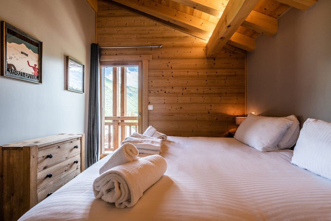 Morzine accommodation - Chalet Balata - Cosy double bedroom with bed linen and landscape views at hot tub chalet Balata Morzine