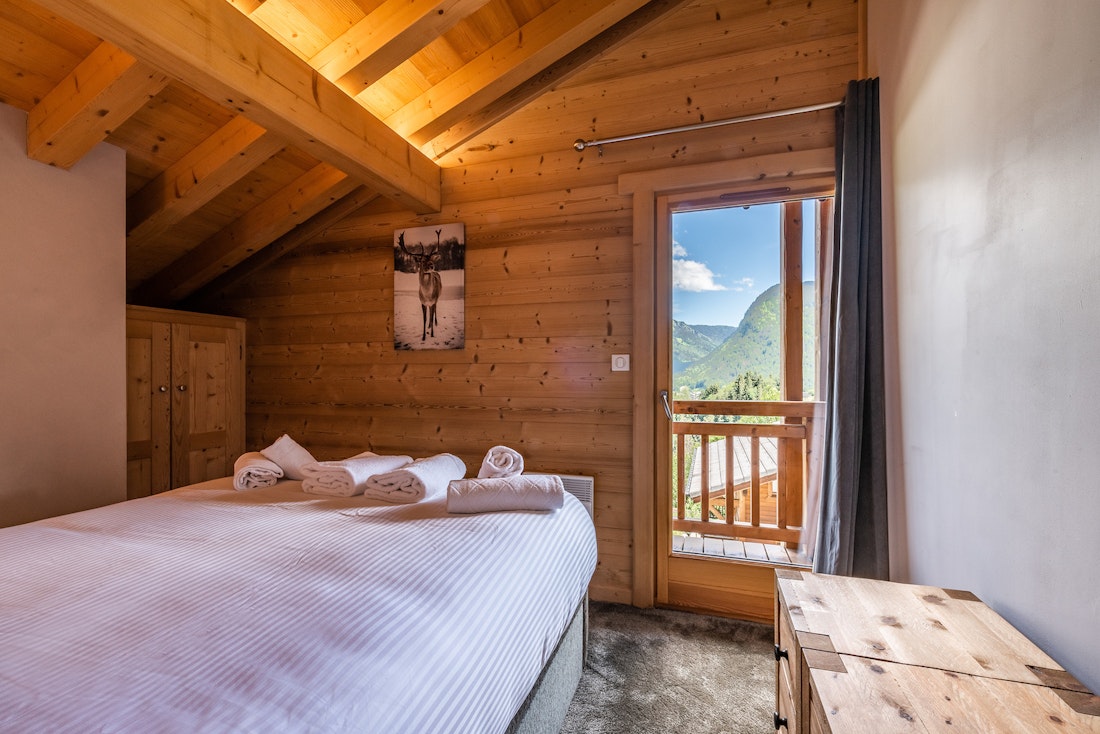 Luxury double ensuite bedroom balcony overlooking the French Alps hotel services chalet Balata Morzine