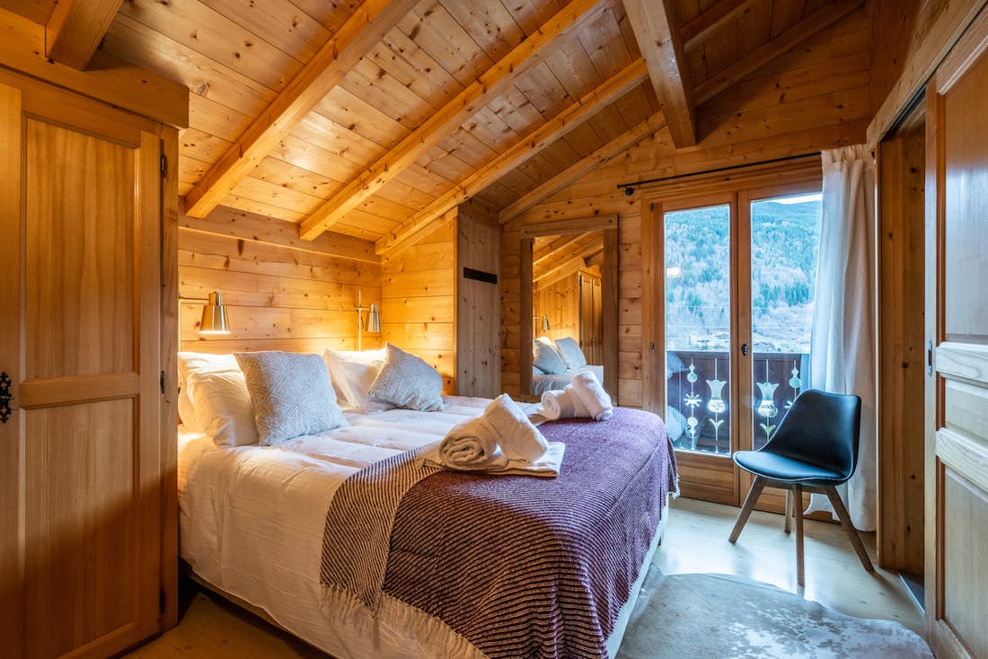 Morzine accommodation - Chalet Doux Abri - Cosy double bedroom with ample cupboard space and landscape views at alps chalet Doux-Abri Morzine