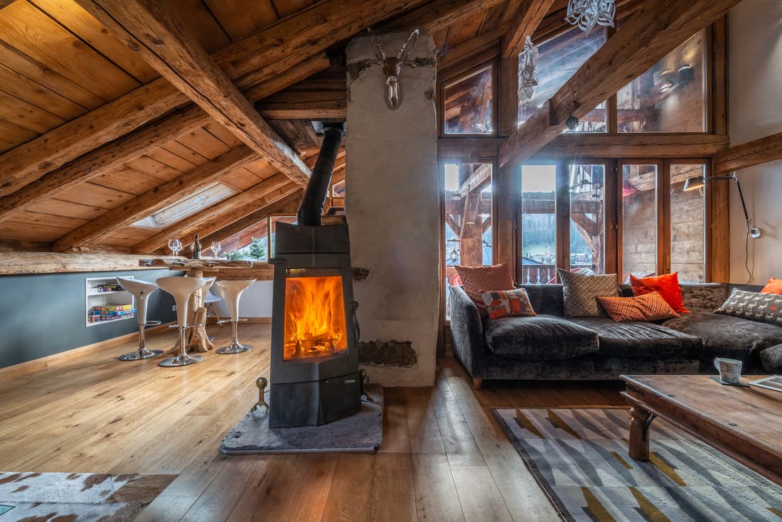 Cosy living room fireplace luxury family chalet La Ferme de Margot Morzine