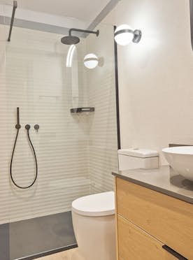 Val de Ruda - 5 Baqueira Beret accommodation - Apartment Aliso - Modern bathroom with wooden accents, a vessel sink on a wooden vanity, a wall-mounted toilet, a bathtub with a glass enclosure, and a large window.