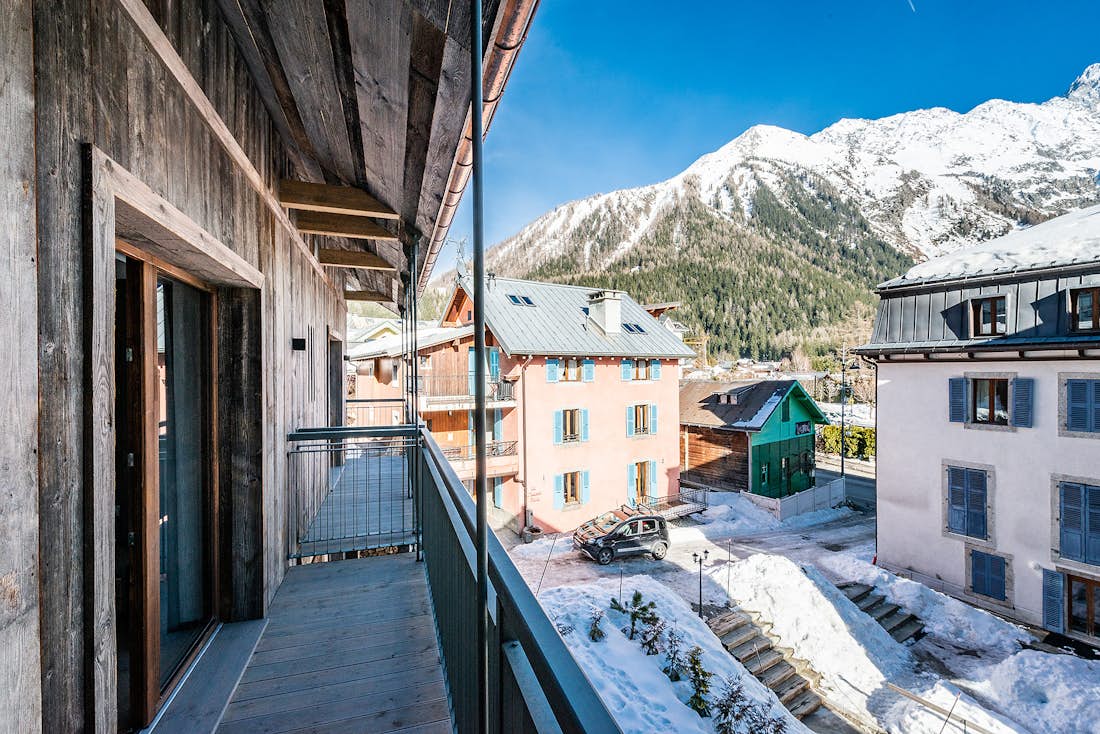 Chamonix accommodation - Chalet Herzog - A wooden terrace with mountain views over the Alps at the luxury family Chalet Herzog in Chamonix