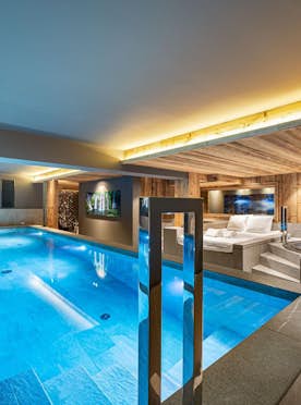 Megeve accommodation - Chalet Orcia - A large indoor swimming pool in a wooded area.