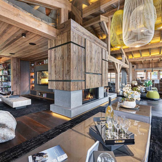 Megeve accommodation - Chalet Orcia - A living room with wooden walls and large windows.