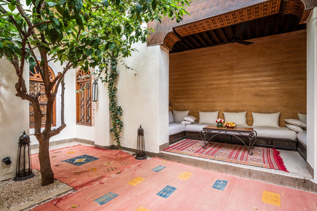 Patio of Adilah riad in Marrakech featuring berber rugs and lemon trees