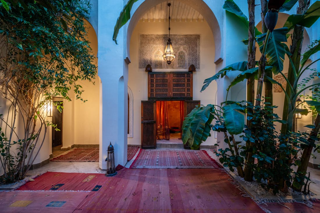 Patio with red berber rugs at Adilah riad in Marrakech