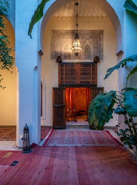 Patio with red berber rugs at Adilah riad in Marrakech