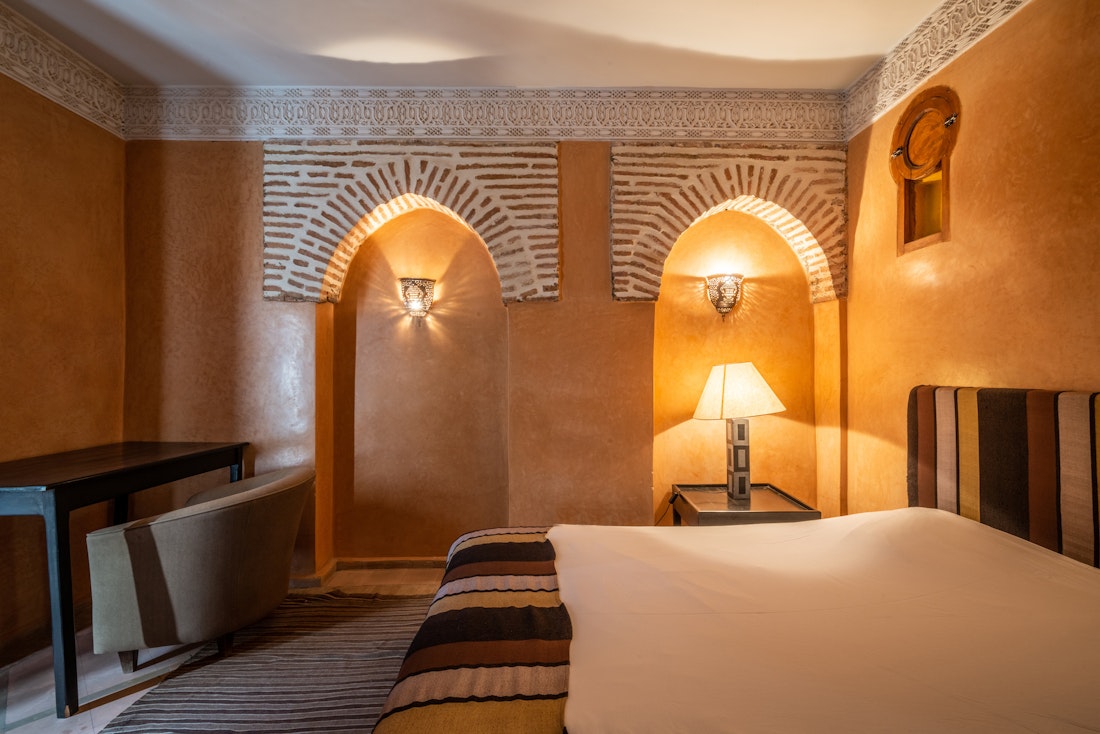 Double bedroom with brick wall details at Adilah riad in Marrakech