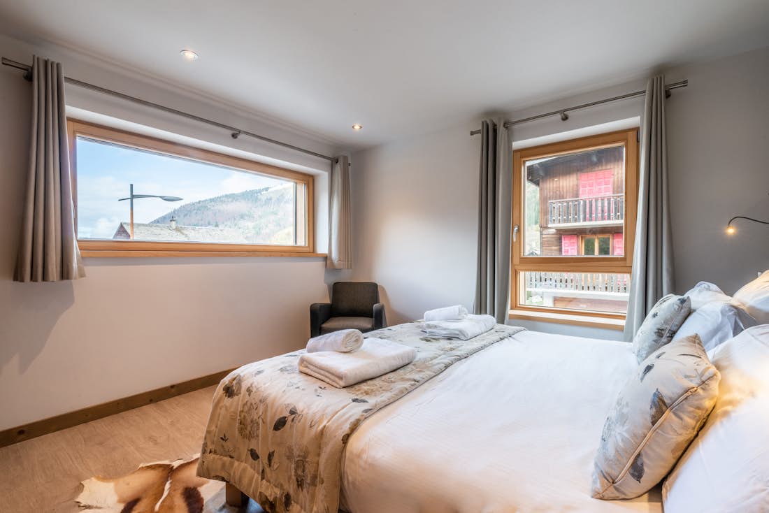 Morzine accommodation - Apartment Flocon - Cosy double bedroom with ample cupboard space and landscape views at hotel services apartment Flocon in Morzine