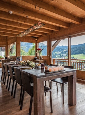 Large wooden dining table views the Alps hot tub chalet Omaroo I Morzine