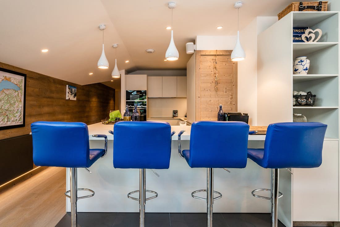 Les Gets location - Appartement Ozigo - Cuisine américaine moderne avec chaises hautes bleu électrique dans famille appartement Ozigo Les Gets