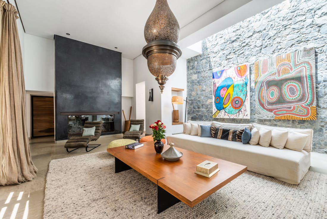 Modern living room with stone wall at Marhba luxury private villa in Marrakech