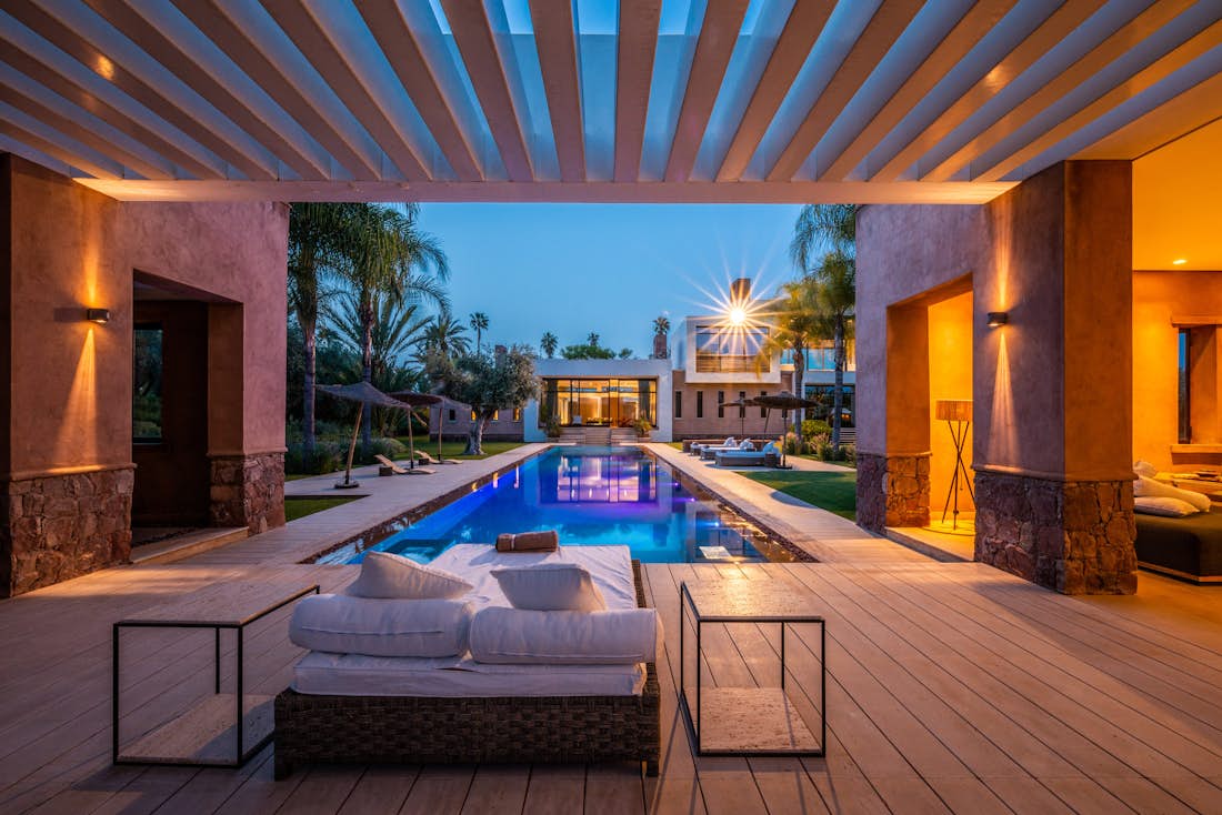 Views of the swimming pool at night from the outdoor lounge of Zagora private villa in Marrakech