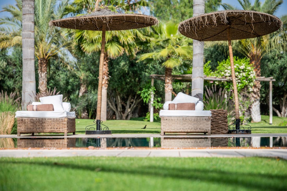 Raffia sunbeds near the pool of Zagora private villa in Marrakech