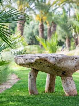 Wooden bench in the private garden of Marhba luxury private villa in Marrakech