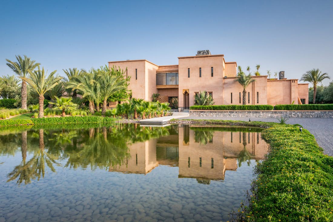Private lake and garden with palm trees at Marhba luxury private villa in Marrakech