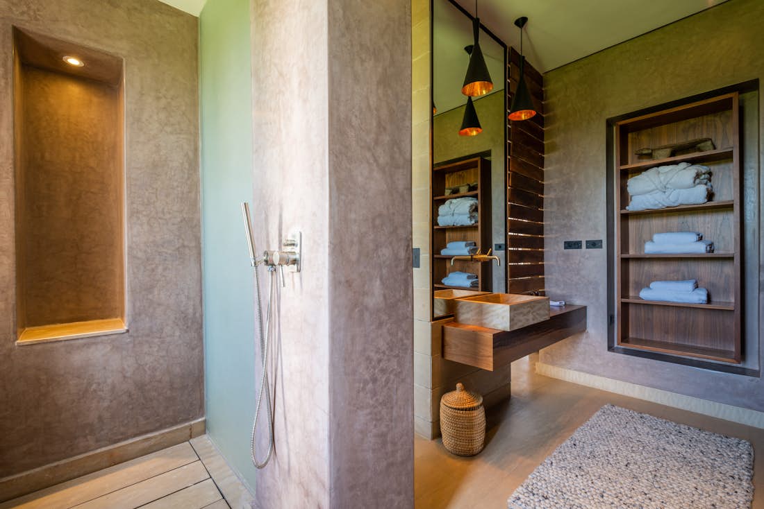 Ethnic bathroom with concrete shower at Zagora private villa in Marrakech