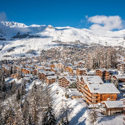 An aerial view of a ski village in the mountains.
