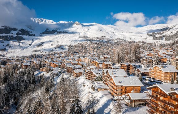 An aerial view of a ski village in the mountains.