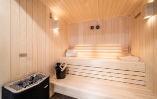 Morzine accommodation - Chalet Bellatrix - A sauna room with a wooden bench and a towel.