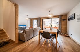 Les Gets accommodation - Apartment Edelweiss - A living room with wooden floors and a dining table.