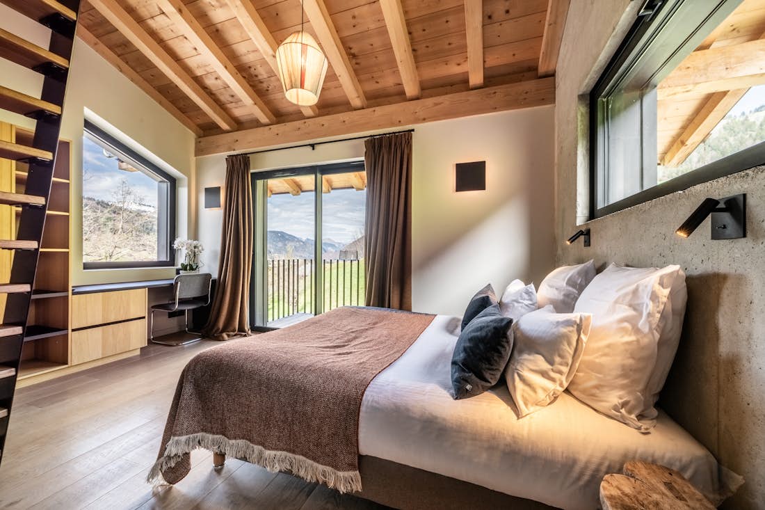 Morzine accommodation - Chalet Nelcote - Cosy double bedroom with ample cupboard space and landscape views at eco-friendly chalet Nelcôte Morzine