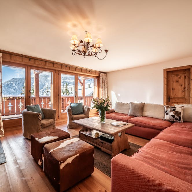 Verbier accommodation - Apartment Ayous - A living room with a fireplace and a view of the mountains. Verbier accommodation - Apartment Ayous - A living room with a fireplace and a view of the mountains.