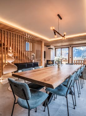 Morzine location - Chalet Bellatrix - A wooden dining room with a view of the mountains.
