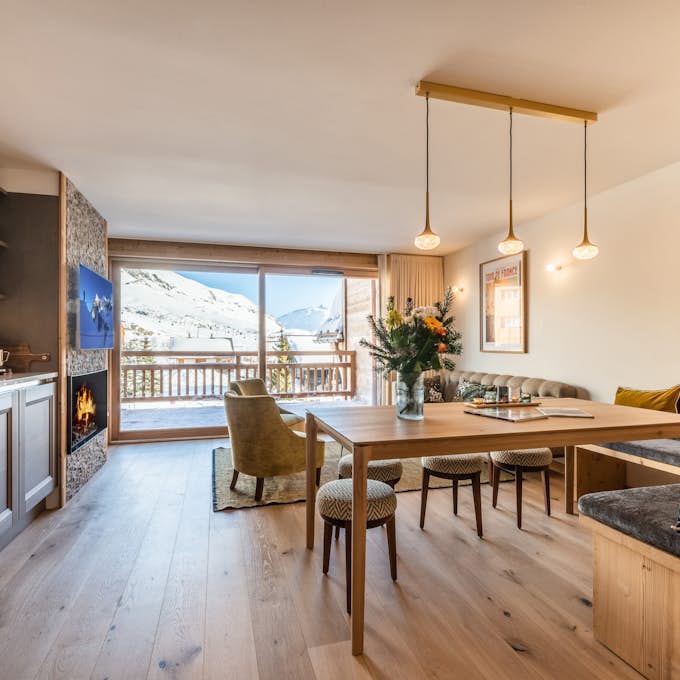 Alpe d'Huez Property management A kitchen and dining area in a mountain apartment.