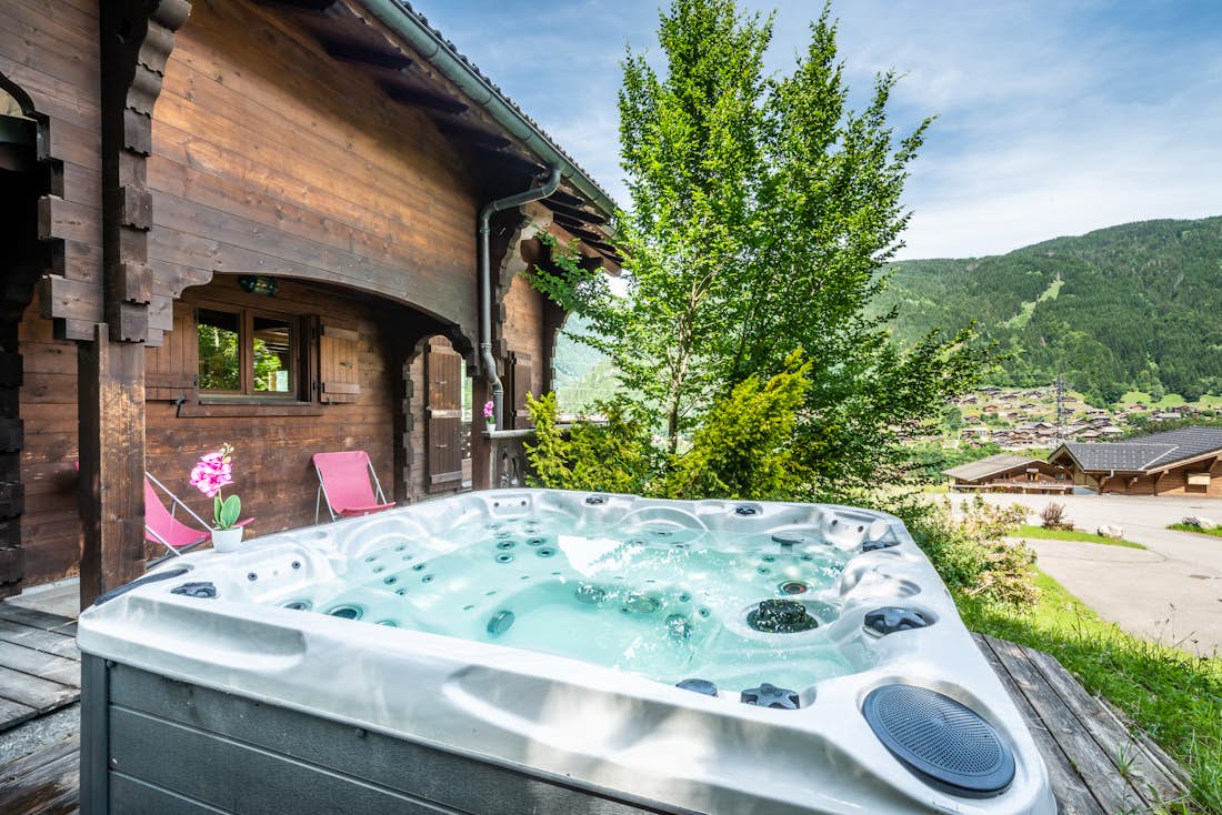 Outdoor hot tub terrace mountain views chalet Doux Abri Morzine