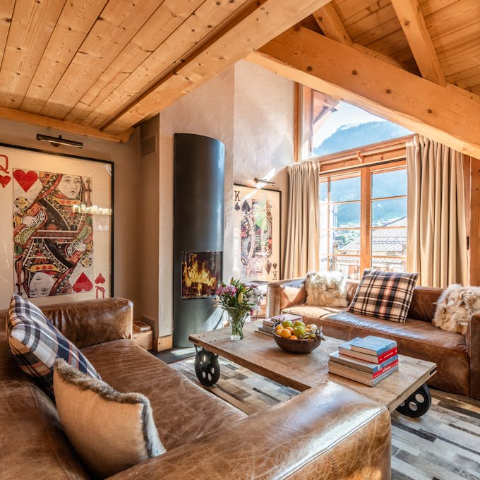 Portes du Soleil Property management A living room with a fireplace and wooden beams.