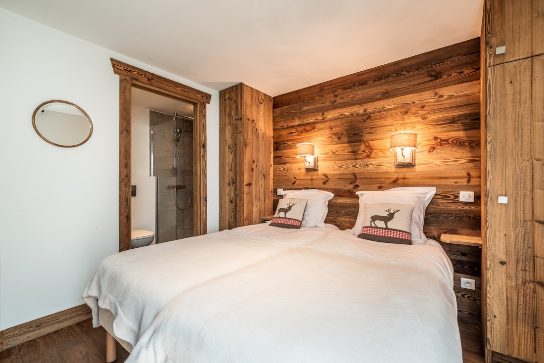 Cosy wood panelled double bedroom mountain views ski in ski out apartment Moabi Courchevel Le Praz