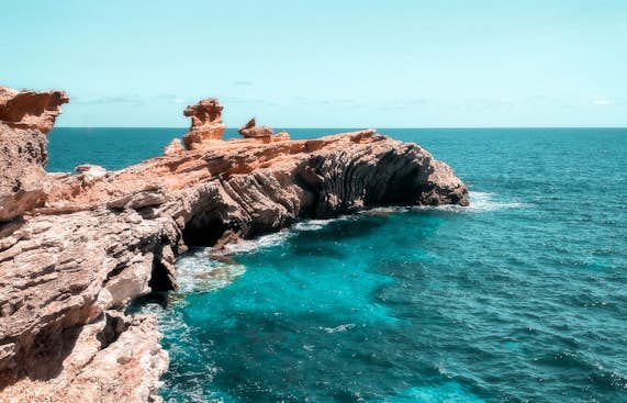 A rocky cliff overlooking the ocean.