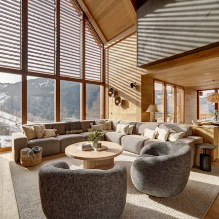 A living room with large windows overlooking the mountains.