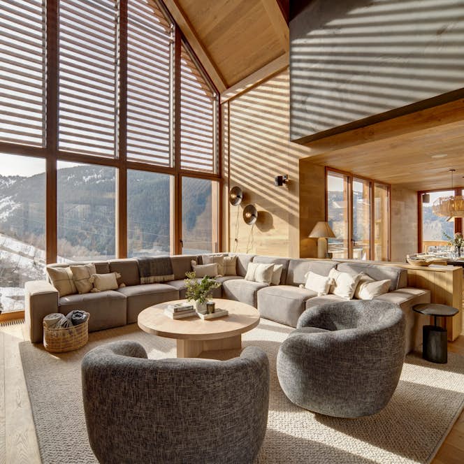 Baqueira Beret accommodation - Chalet Timok  - A living room with large windows overlooking the mountains.
