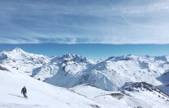 A person skiing down a snow covered mountain
