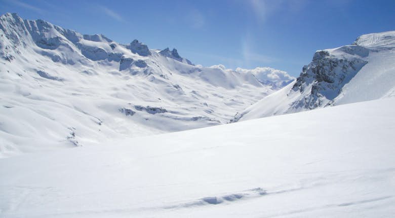 A person is skiing down a snow covered slope
