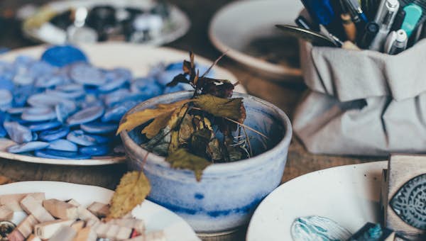 A table full of plates with art supplies on it
