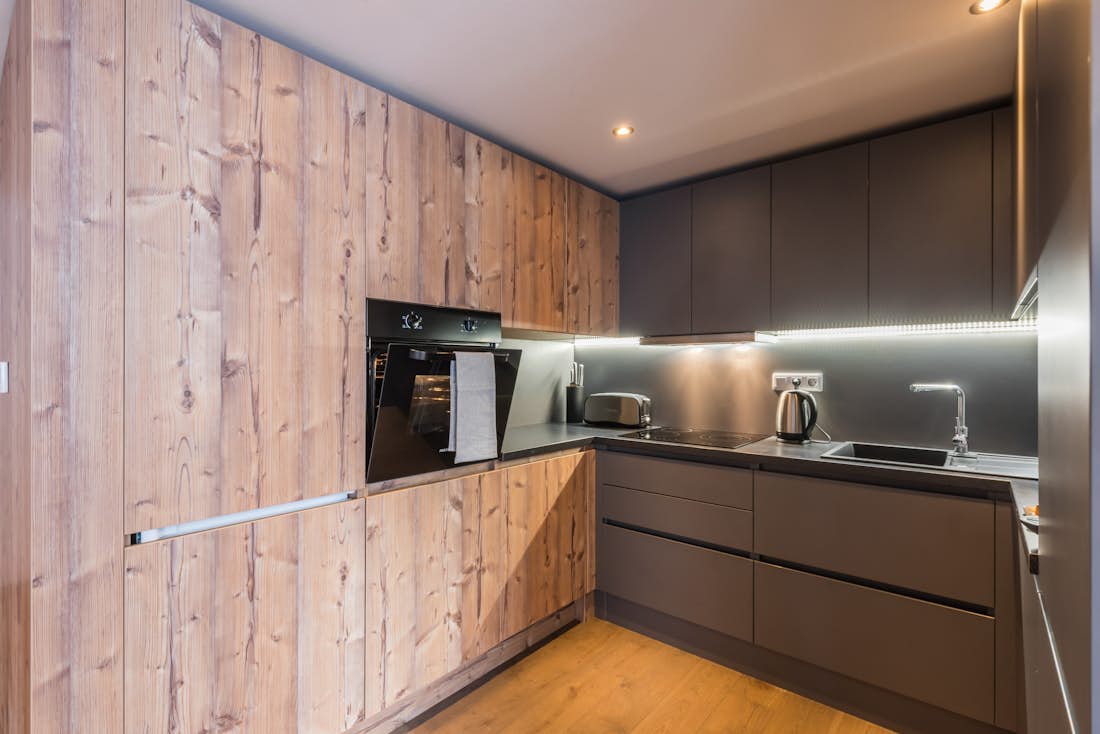 Morzine location - Appartement Ayan - Une cuisine contemporaine en bois équipée dans l'appartement de luxe Ayan avec services hôteliers à Morzine