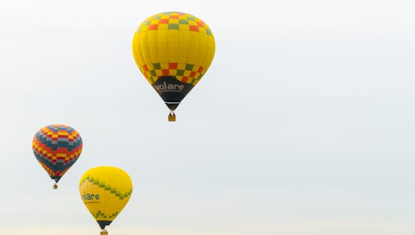 A group of hot air balloons flying in the sky