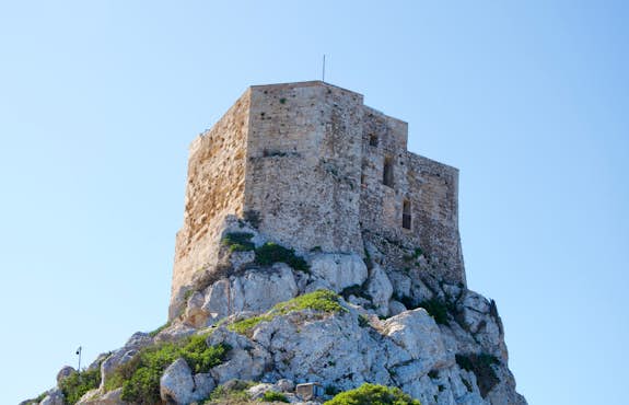 A castle on top of a rocky hill.