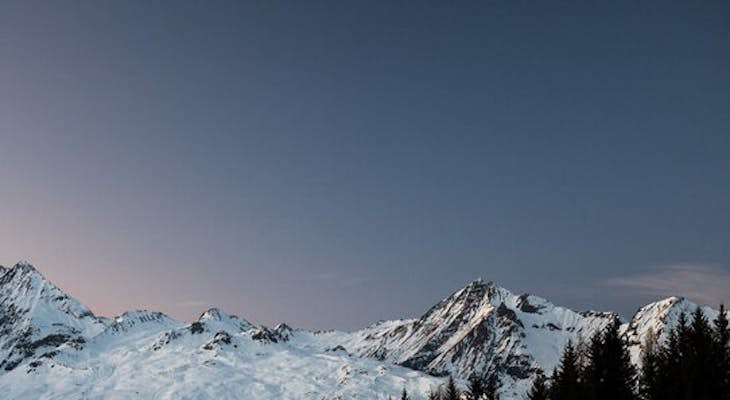 Ice blue mountains in the evening sky background of Les Arcs 